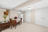 Spacious room featuring light-toned tile flooring, neutral wall paint, and white trim