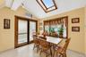 Vaulted ceiling with skylight and wood-framed window
