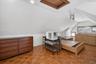 Room featuring sloped ceilings, parquet wood-finish flooring, recessed lighting, and a wood-frame attic access hatch