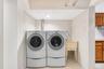 Dedicated laundry area featuring a side-by-side washer and dryer set