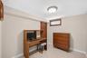 Cream-colored walls complimenting a tiled floor, featuring a built-in window and a flush-mount ceiling light