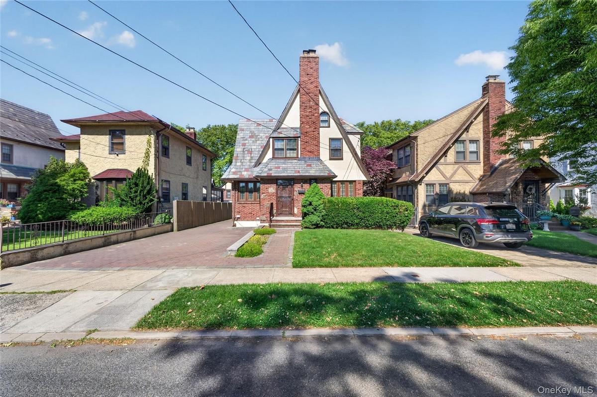 Distinctive architectural character featuring a brick facade with a slate roof