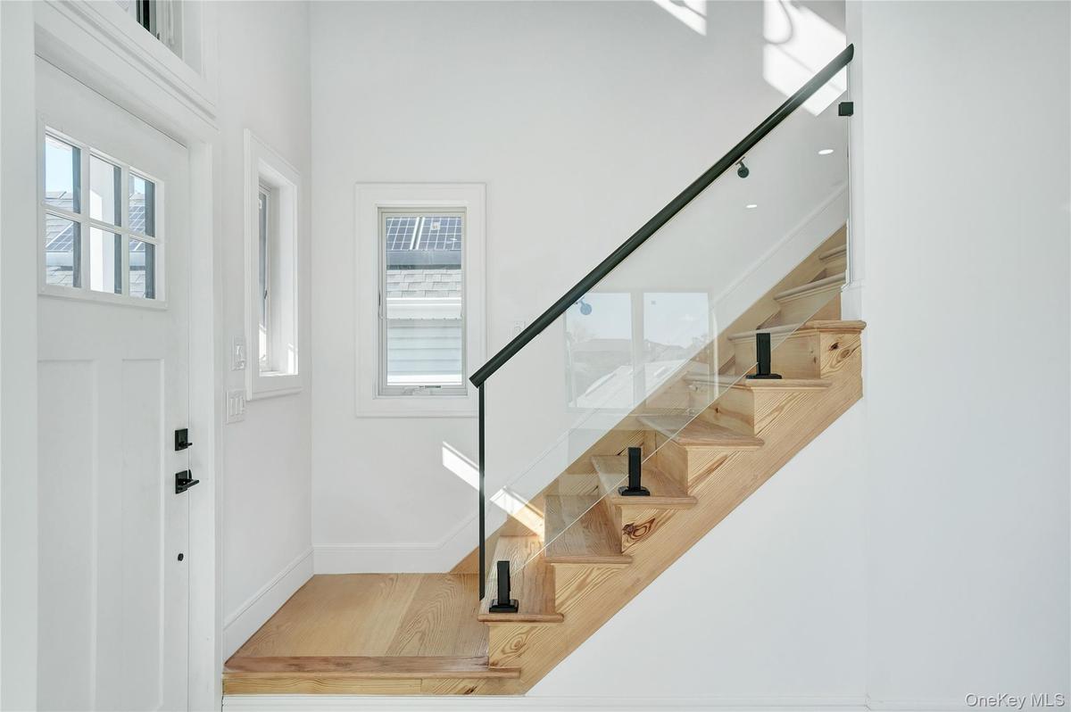 Entrance foyer featuring stairway and wood finished floors