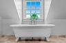 Full bathroom with vaulted ceiling and a freestanding tub