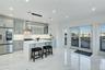 Kitchen featuring stainless steel refrigerator with ice dispenser, glass insert cabinets, a kitchen island, light marble finish flooring, and a breakf