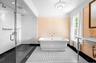 Full bathroom with a freestanding bath, a stall shower, and vanity