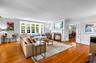 Living area with a fireplace , french doors, light wood-type flooring, and ornamental molding