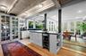 Kitchen featuring eat in area, open shelves, dark countertops, light wood-style floors, beam ceiling, and white cabinets