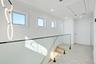 Corridor featuring attic access, ornamental molding, and recessed lighting