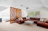 Living area with carpet floors and a baseboard heating unit