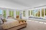 Bedroom featuring carpet, crown molding, access to exterior, french doors, and beamed ceiling