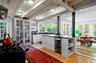 Kitchen featuring open shelves, light wood-style floors, black range with gas cooktop, beamed ceiling, and extractor fan
