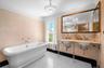Full bathroom featuring a freestanding tub and dual sinks