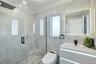 Full bathroom featuring a marble finish shower, ornamental molding, vanity, tile walls, and recessed lighting