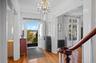 Foyer with light wood-style flooring, radiator heating unit, a chandelier, and ornamental molding