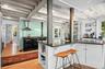 Kitchen with healthy amount of natural light, open shelves, white cabinetry, and a wood ceiling with exposed beams