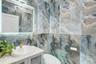 Half bath with tile walls and vanity