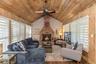 Den with wood burning fireplace