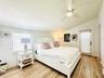 Second bedroom with a door leading straight to backyard, jacuzzi & pool.