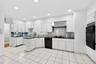 Eat-In Kitchen with Ample Storage and a dedicated Prep area with its own sink and fridge