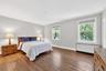 Spacious Primary Bedroom facing East with Beautiful Hardwood Floors, and Full bathroom