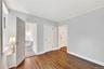 Alternate view of Bedroom #1 with view of the powder room and closet with custom shelving