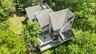 A rare aerial perspective of a truly unique estate, set on 6 private acres and surrounded by 30 + acres of protected natural beauty. From above, the h