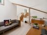 A striking loft library features soaring cathedral ceilings, unique architectural details, and floor-to-ceiling bookshelves with a classic library lad