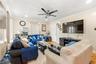 Living space featuring wood-finish flooring, crown molding, and recessed lighting