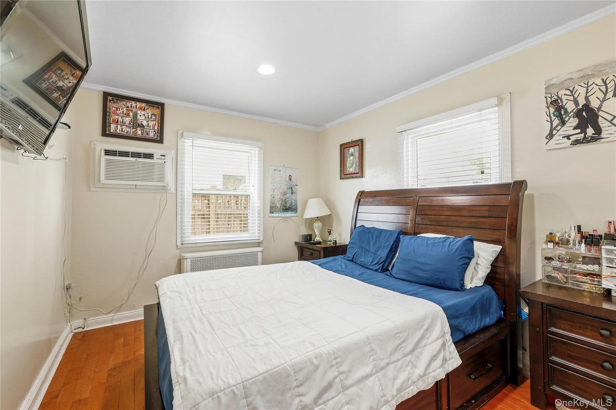 Wood-finish flooring and light-toned walls create a neutral backdrop for the room