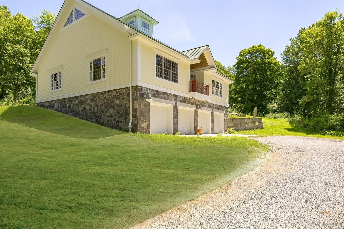 Exterior with a stone foundation and newly painted Hardie Board Siding