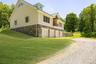 Exterior with a stone foundation and newly painted Hardie Board Siding