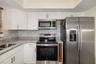 Kitchen – Close (Appliances)Updated kitchen featuring stainless steel appliances, granite countertops, and modern cabinetry.Updated kitchen featuring 