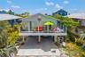 Bright coastal exterior with generous deck space, perfect for enjoying the island lifestyle.