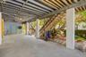 Large covered area below the home providing parking, storage, and flexible use space.