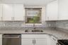Kitchen window provides natural light while overlooking the outdoor space.Bright kitchen with window over sink bringing in natural light and garden vi