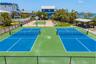 Recreation area with pickleball and basketball courts alongside Sarasota Bay.