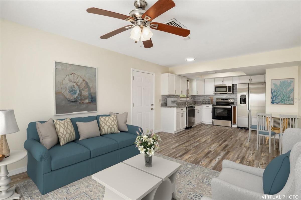 Virtually Staged Living RoomLight-filled living area with open layout and seamless flow into the kitchen and dining space.