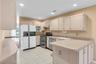 Kitchen featuring light-toned cabinetry, a double oven range, stainless steel dishwasher, and recessed lighting