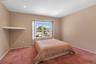 Carpeted room featuring a large window, neutral wall paint, and recessed ceiling lighting