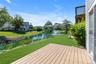 Expansive Trex - deck overlooking a lake with a central fountain