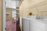 Dedicated laundry area featuring a washer and dryer, complemented by overhead wire shelving