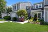 Shingle-style exterior with white trim windows and a dark shingle roof