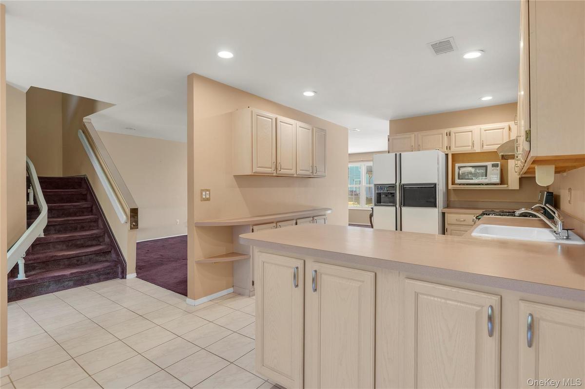 Kitchen featuring wood-finish cabinetry, integrated oven, and a built-in microwave