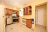 Kitchen featuring wood cabinetry, patterned flooring, recessed lighting.