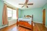 Spacious primary bedroom with pre-engineered hardwood flooring.