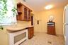 Wood-finish cabinetry with glass inserts, and a built-in countertop.