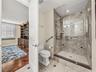 The walk-in shower has both a handheld shower and grab bars for safety. The frameless shower enclosure is an elegant addition.  And of course, it is a
