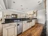 The dishwasher with integrated door is to the right of the sink.