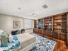 This is the third bedroom. It previously served as an office. The custom walnut shelving and cabinets also lend this room to being a library. And with